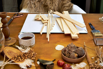 Creative process of making a wooden organizer for a dried flower collage. Wooden planks, natural...