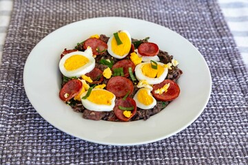 Traditional black bean tutu with kale, calabrese sausage, bacon and egg. A classic rustic dish from Minas Gerais