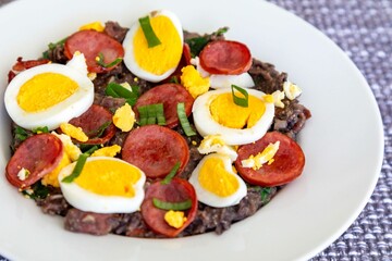 Traditional black bean tutu with kale, calabrese sausage, bacon and egg. A classic rustic dish from Minas Gerais