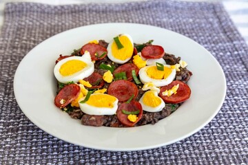 Traditional black bean tutu with kale, calabrese sausage, bacon and egg. A classic rustic dish from Minas Gerais