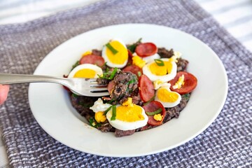 Traditional black bean tutu with kale, calabrese sausage, bacon and egg. A classic rustic dish from Minas Gerais