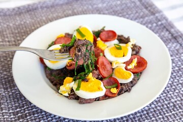 Traditional black bean tutu with kale, calabrese sausage, bacon and egg. A classic rustic dish from Minas Gerais