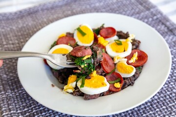 Traditional black bean tutu with kale, calabrese sausage, bacon and egg. A classic rustic dish from Minas Gerais