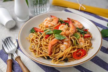 Stir Fried Spicy Spaghetti with shrimps in a white plate 