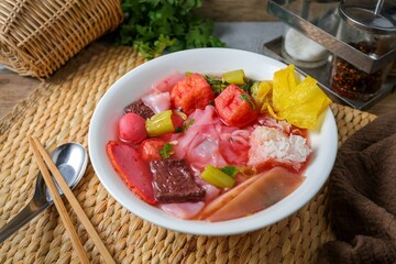 Pink Noodle Soup with meat balls and vegettable , thai called yen ta fo	