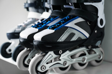 Pairs of roller skates in shelving unit, closeup