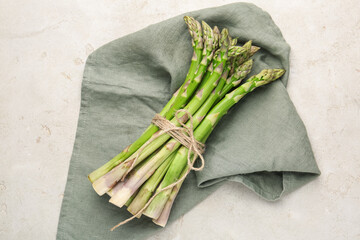 Fresh raw asparagus on light grey table, top view
