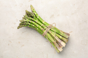 Fresh raw asparagus on light grey table, top view