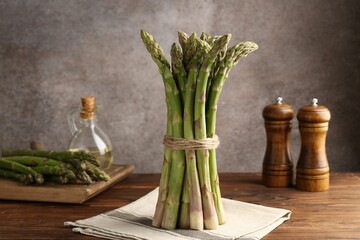 Fresh raw asparagus on wooden table, closeup