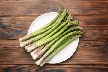 Fresh raw asparagus on wooden table, top view