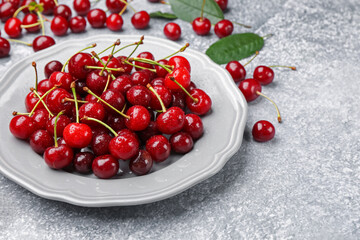 Wet ripe cherries on light table, closeup
