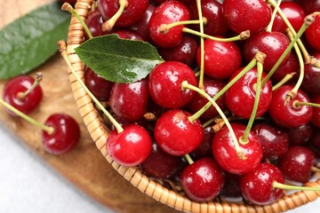 Wet ripe cherries on light table, closeup