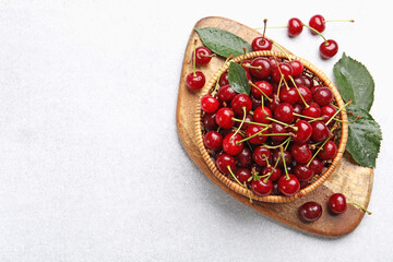 Wet ripe cherries on light table, flat lay. Space for text