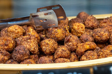 Meat and fish balls, savory mixed protein appetizer, cooked meatballs with seafood blend close-up