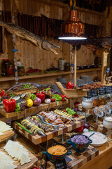 Original buffet table setup with Romanian cuisine featuring dried fish, vegetables, spreads, and...