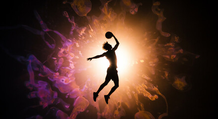 Fototapeta premium Dynamic silhouette of a basketball player jumping against a vibrant abstract glowing background representing energy and motion