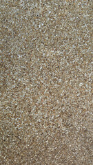 Granular Abstract Texture: A close-up view showcasing a granular, beige texture. This macro shot highlights the detailed composition of tiny, irregular particles.
