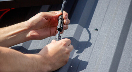 Technician Installing Solar Panels on Metal Roof