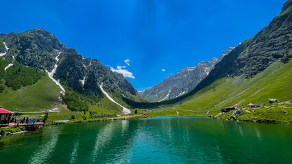 Stunning turquoise waters of Rainbow Lake in Domel, Minimarg, Gilgit-Baltistan, Pakistan. Surrounded by mountains, this scenic alpine lake reflects the natural beauty of northern Pakistan.

