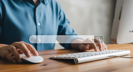 Person using computer searching online blue shirt keyboard