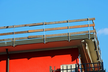 corner of the roof of the apartment building with the barrier firmly installed for the protection...