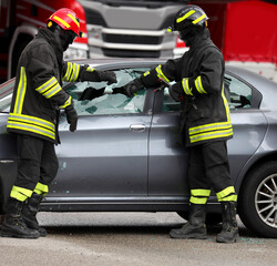 Exact moment when glass from car shatters because it is broken go firefighters to free injured after accident