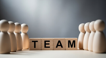 Wooden figures and word blocks spelling team unity