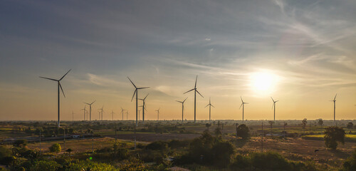 Banner group of wind turbines at sunset in windmill field