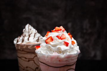 Milkshakes of different flavors on a dark background.