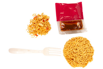 Cup of instant noodles, condiments, plastic forks on white background