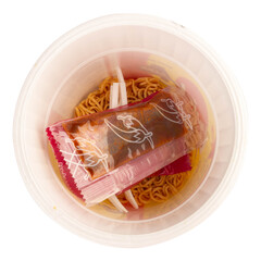 Instant noodle cup top view plastic fork white background