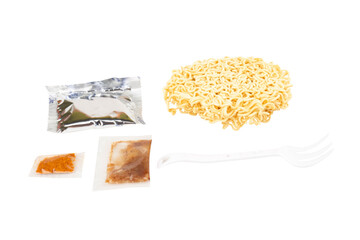 Cup of instant noodles, condiments, plastic forks on white background