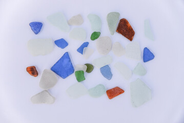 Sea glass isolated on white background, Sea Glass Mosaic, patterns made from Ocean glass, its a lifestyle background made with natural colours of blue, green, brown and white, Beach summer background.