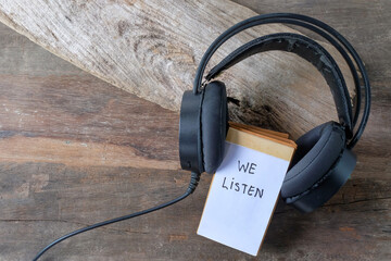 We listen text written on notebook covered with headphones.