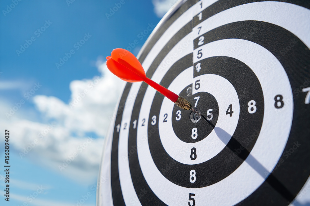 Poster achieving goals with precision a close up view of a dart hitting the bullseye on a target against a 