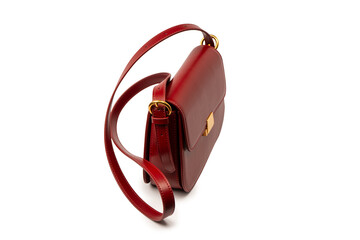 Burgundy shoulder leather bag isolated on white background.