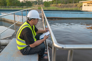 Fototapeta premium Environmental engineers work at wastewater treatment plants,Water supply engineering working at Water recycling plant for reuse