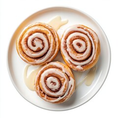 Fototapeta premium Three cinnamon rolls with glaze on a plate isolated on white background