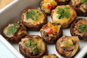 Tasty stuffed mushrooms in baking dish, above view