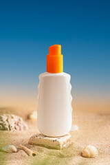 Sunblock or sunscreen in cosmetic tube on beach sand and beige background. Summer vacation and skin care concept with starfish and sea shells, spf uv-protect cosmetics. Skin health. High quality photo