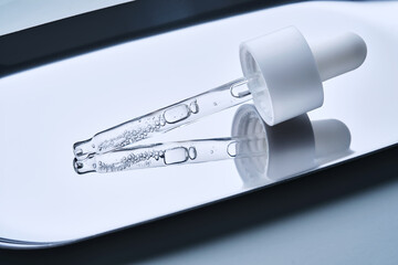 A serum pipette on a steel tray.