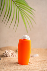 Sunblock or sunscreen in cosmetic tube on beach sand and beige background. Summer vacation and skin care concept with starfish and sea shells, spf uv-protect cosmetics. Skin health. High quality photo