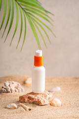 Sunblock or sunscreen in cosmetic tube on beach sand and beige background. Summer vacation and skin care concept with starfish and sea shells, spf uv-protect cosmetics. Skin health. High quality photo