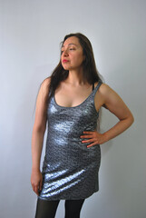portrait of a young beautiful latina woman in sparkle dress with serious expression