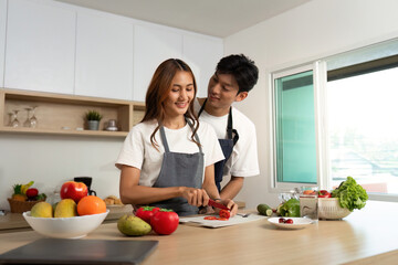 Couple Cooking Together. Smiling While Preparing Fresh Ingredients.