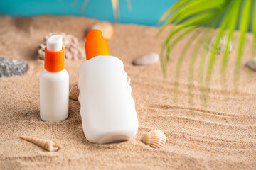 Sunblock or sunscreen in cosmetic tube on beach sand and beige background. Summer vacation and skin care concept with starfish and sea shells, spf uv-protect cosmetics. Skin health. High quality photo