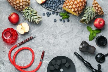 Frame of hookah and fresh fruits on grey table, flat lay. Space for text