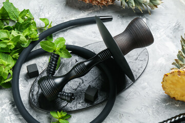 Hookah, coal and fresh fruits on grey table, closeup
