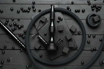 Hookah, coal and currants on black wooden table, flat lay