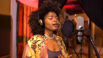 Singer recording new song in professional studio